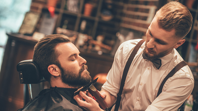 Beard line-up being detailed at Apex Barber Shop